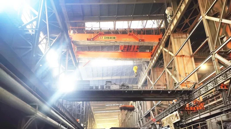 An unmanned metallurgical plant crane is in operation.